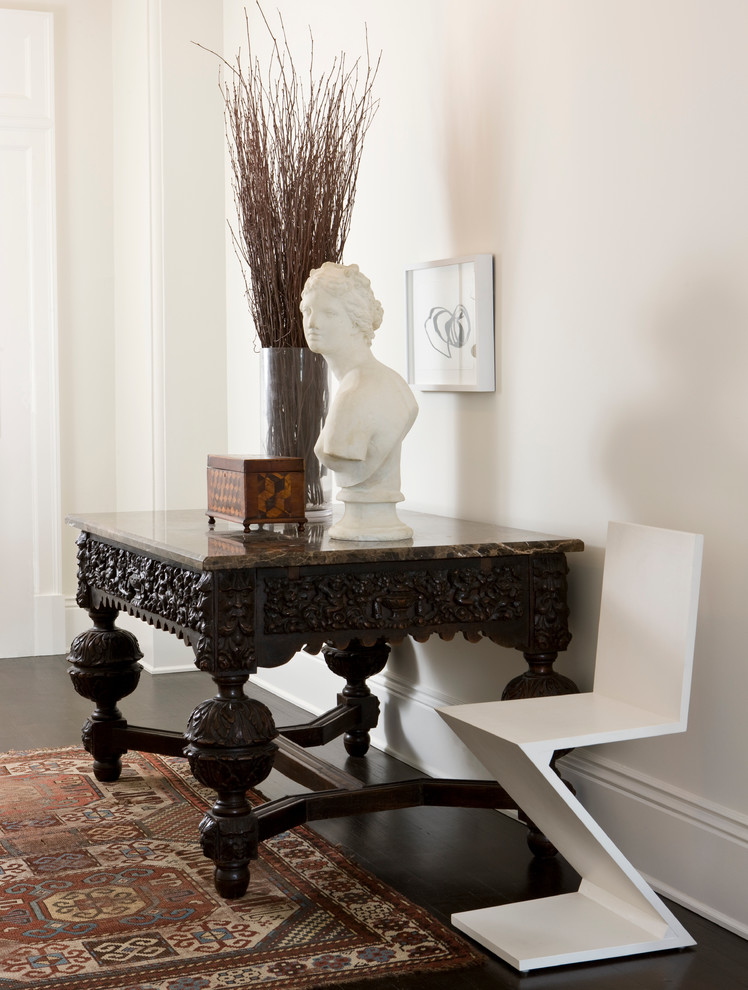 Example of a classic dark wood floor entryway design in Other with white walls