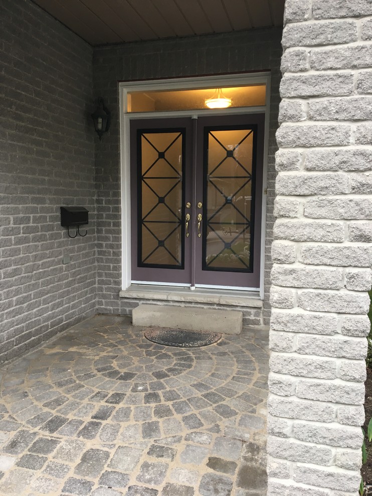 Bild på en mellanstor vintage ingång och ytterdörr, med grå väggar, betonggolv, en dubbeldörr, en lila dörr och grått golv