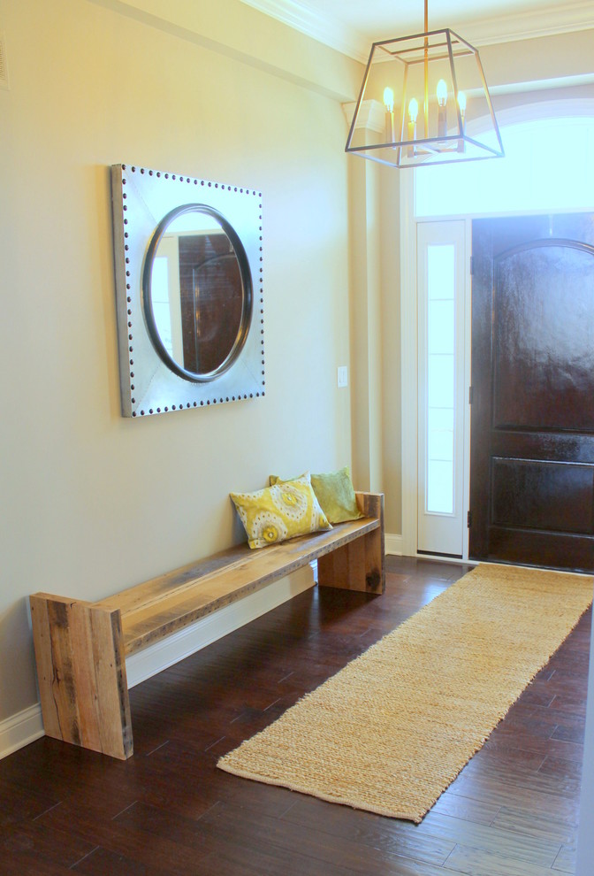 Mid-sized transitional dark wood floor entryway photo in Columbus with yellow walls and a brown front door