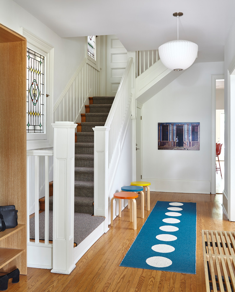 Mid-sized danish light wood floor and beige floor foyer photo in Toronto with white walls