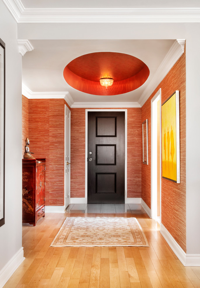 Huge asian light wood floor entryway photo in Toronto with red walls and a dark wood front door