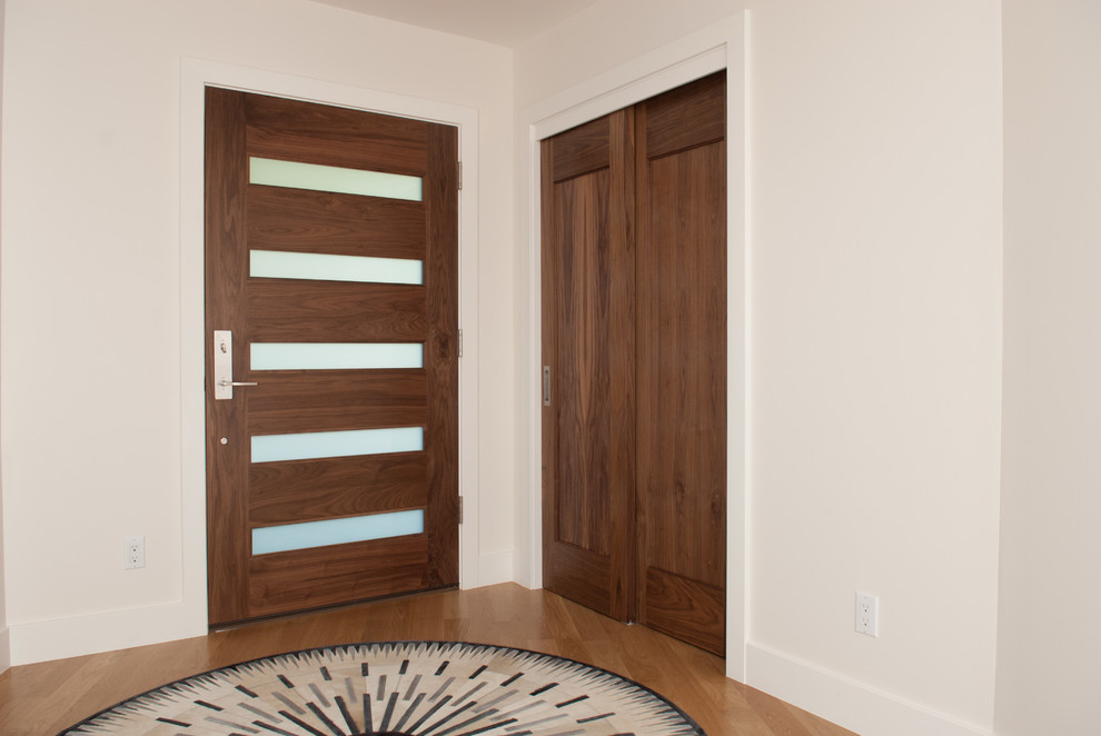 Exemple d'une porte d'entrée rétro avec un mur blanc, parquet clair, une porte simple et une porte en bois brun.