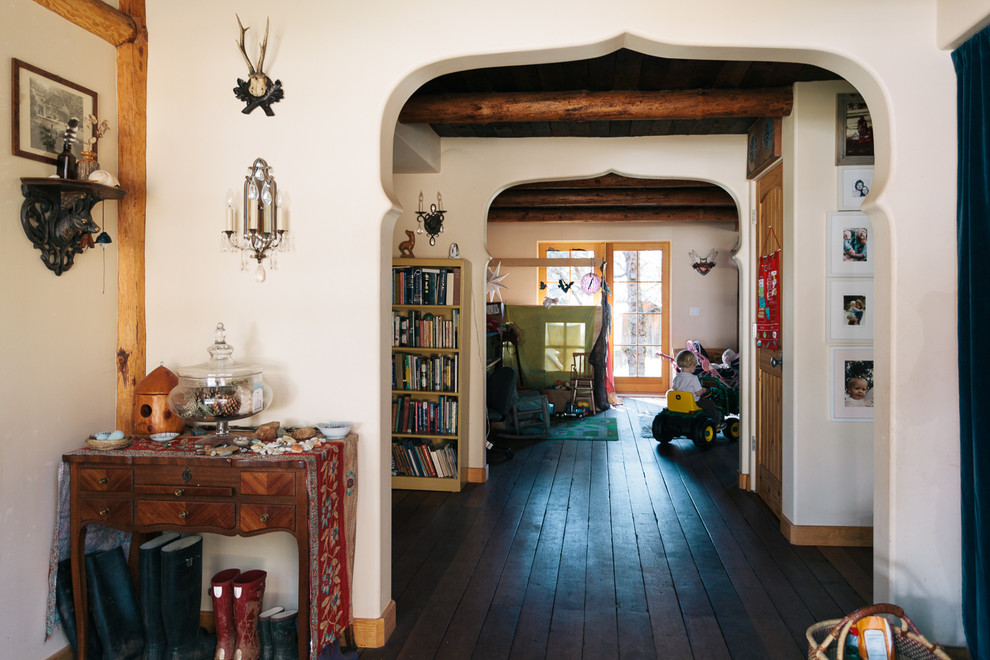 Inspiration for a mid-sized eclectic dark wood floor foyer remodel in Sacramento