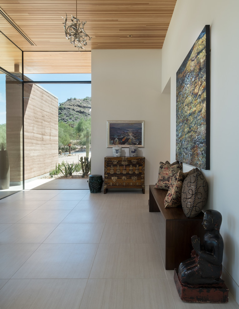 Contemporary foyer in Phoenix with white walls and grey floors.