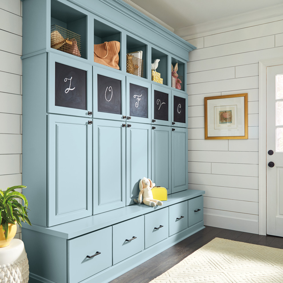 This is an example of a medium sized farmhouse boot room in Other with white walls, dark hardwood flooring, a white front door and brown floors.