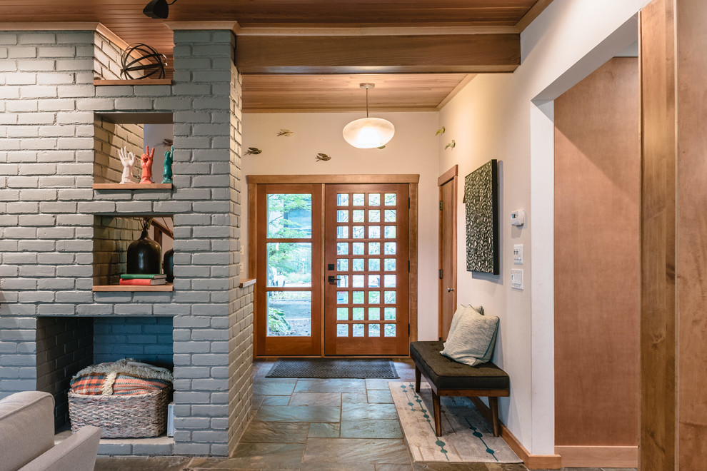 Inspiration for a mid-sized 1950s slate floor and blue floor entryway remodel in Detroit with white walls and a medium wood front door