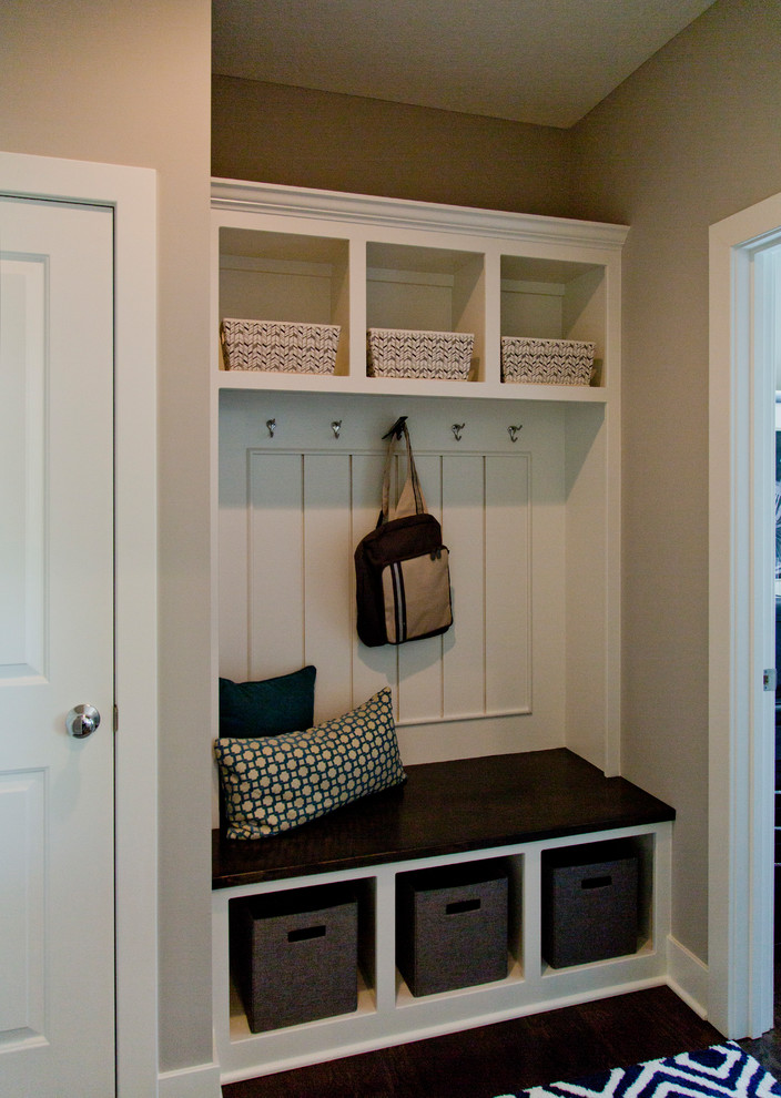 Photo of a small modern boot room in Kansas City with beige walls, dark hardwood flooring, a single front door, a white front door and brown floors.
