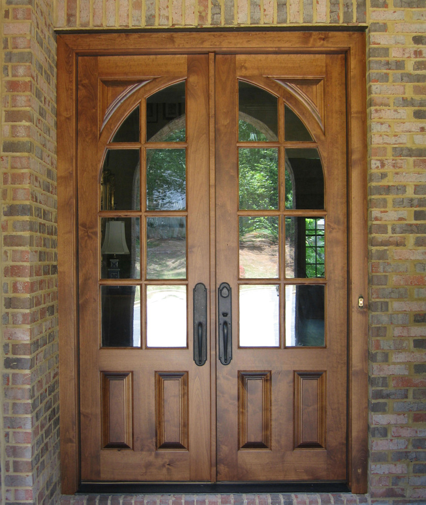 This is an example of a traditional front door in Atlanta with a double front door and a medium wood front door.