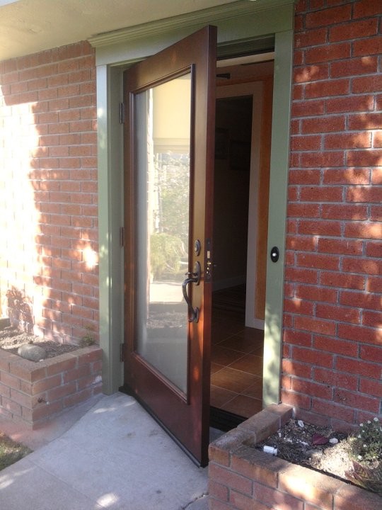 Photo of a medium sized contemporary front door in San Francisco with a single front door and a dark wood front door.