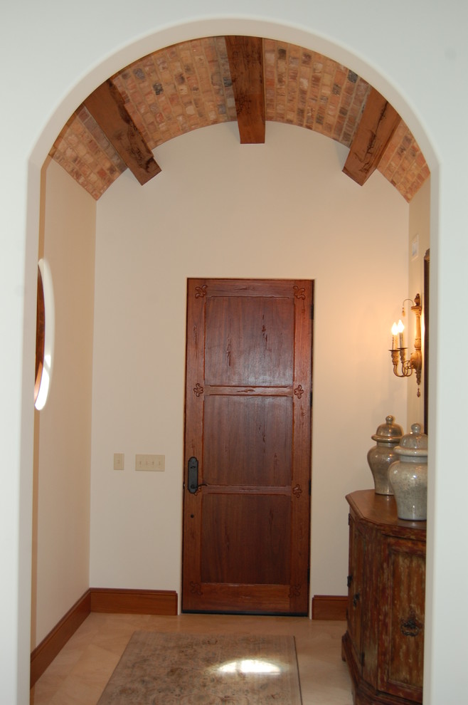 Aménagement d'une porte d'entrée montagne de taille moyenne avec un mur blanc, un sol en carrelage de céramique, une porte simple et une porte en bois foncé.