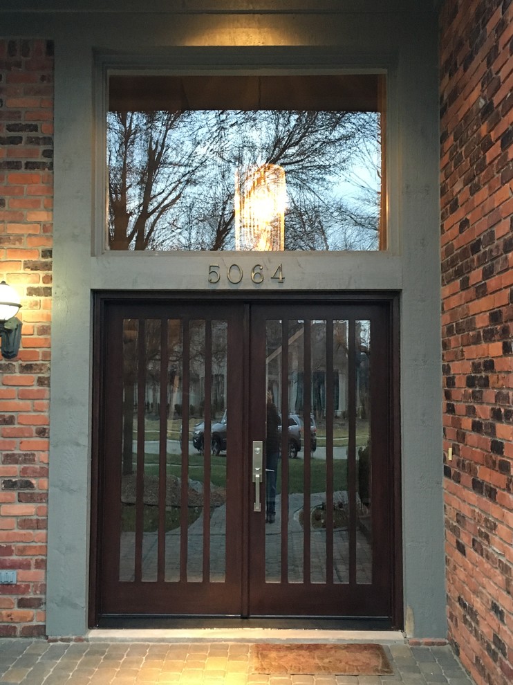 Ejemplo de puerta principal de estilo americano de tamaño medio con paredes marrones, puerta doble, puerta marrón y suelo de pizarra