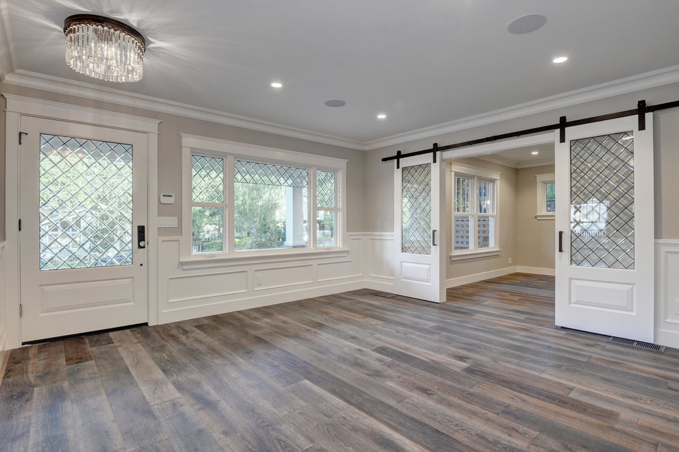 Entryway - mid-sized traditional medium tone wood floor and beige floor entryway idea in San Francisco with beige walls and a glass front door