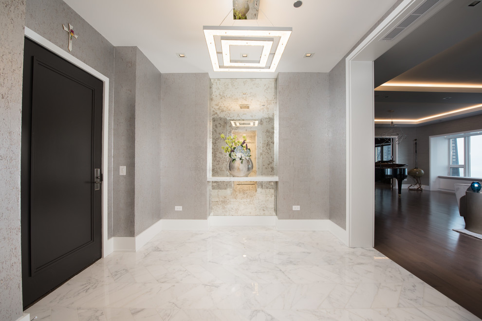Inspiration for a medium sized contemporary foyer in Chicago with marble flooring and white floors.