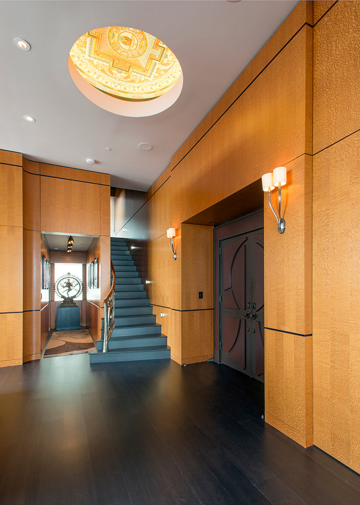 This is an example of a contemporary foyer in Nashville with dark hardwood flooring and a double front door.