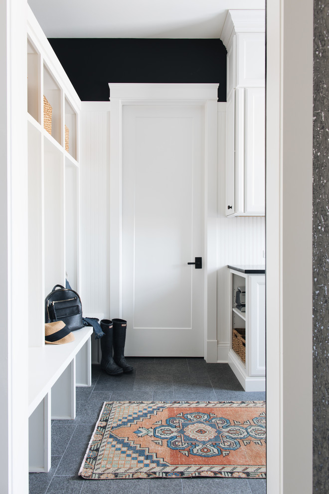 Design ideas for a traditional boot room in Chicago with white walls and grey floors.