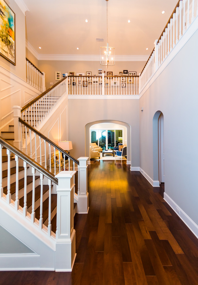 Inspiration for a large timeless medium tone wood floor entryway remodel in Jacksonville with gray walls