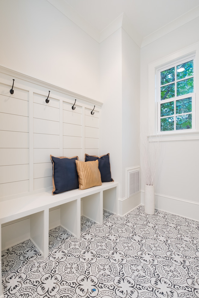 Inspiration for a mid-sized timeless ceramic tile mudroom remodel in Charlotte with white walls