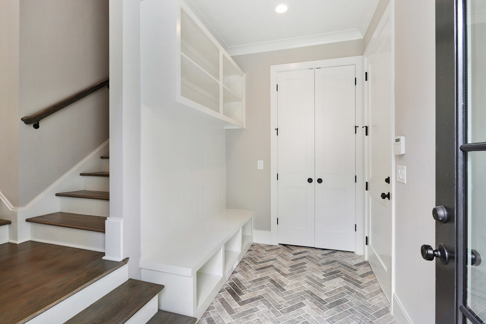 Inspiration for a mid-sized timeless brick floor and multicolored floor mudroom remodel in Atlanta with gray walls