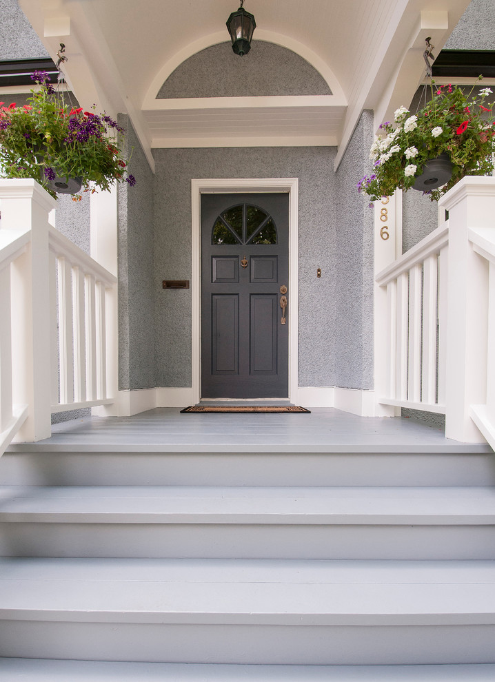 Traditional entrance in Vancouver with grey walls, a single front door and a grey front door.