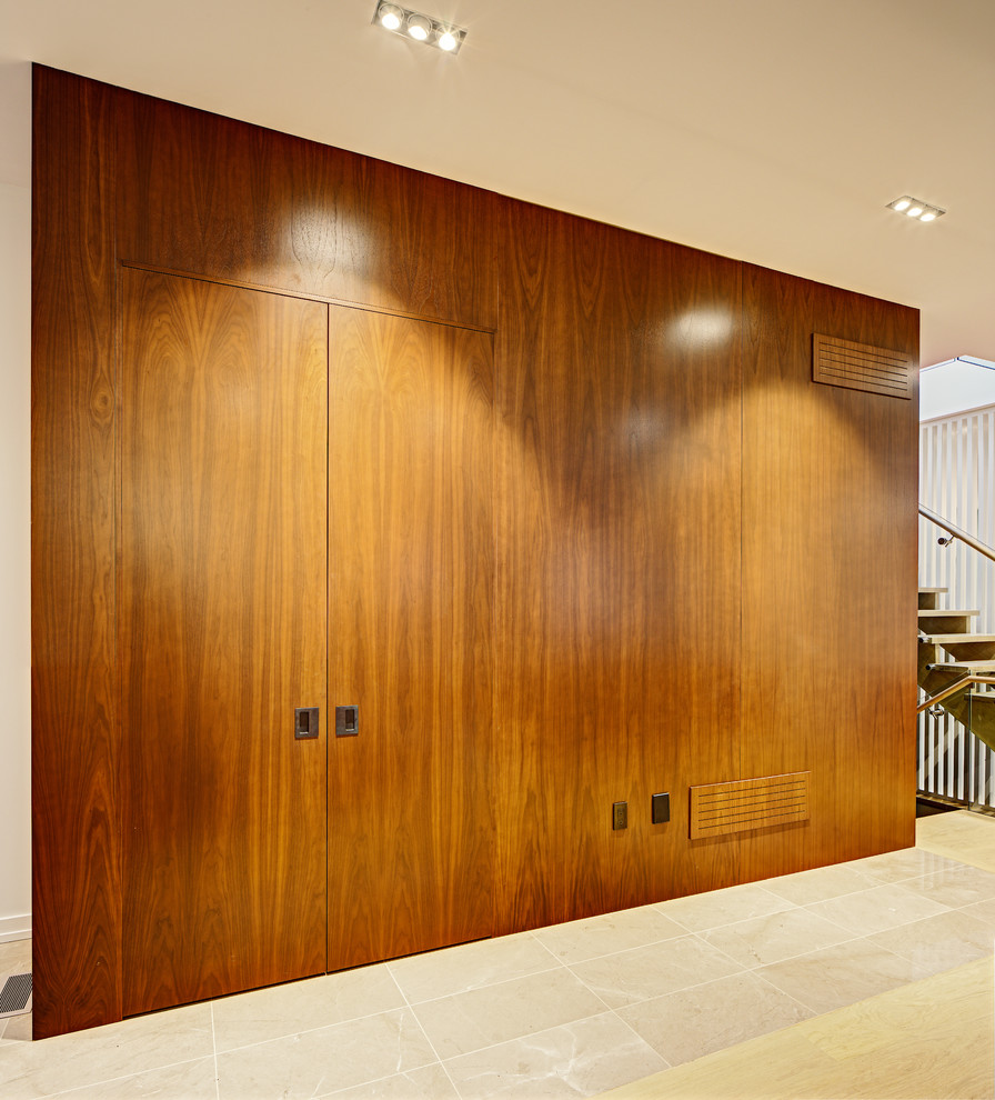 This is an example of a medium sized contemporary foyer in Toronto with a single front door and a medium wood front door.