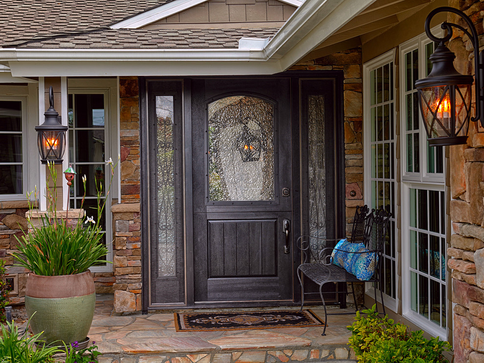 На фото: большая входная дверь в стиле рустика с коричневыми стенами, голландской входной дверью и черной входной дверью
