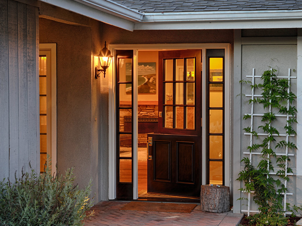 Example of a large trendy entryway design in Orange County with gray walls and a black front door