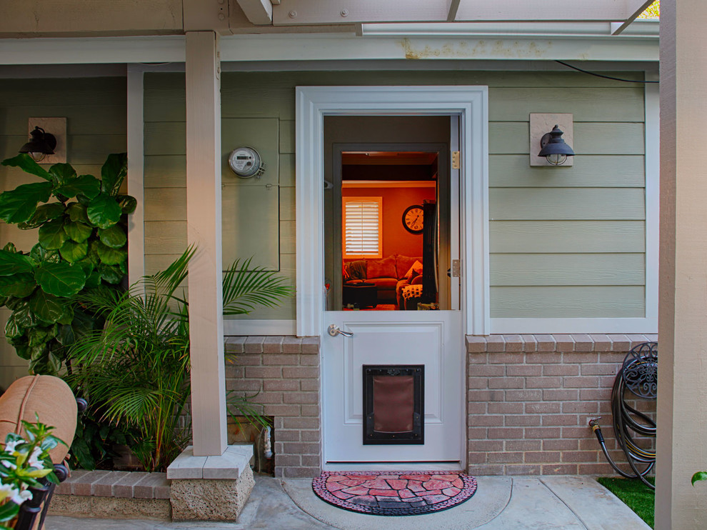 Photo of a medium sized classic front door in Orange County with green walls, a stable front door and a white front door.