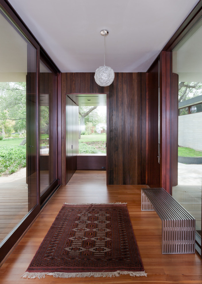 Medium sized modern hallway in Austin with medium hardwood flooring.