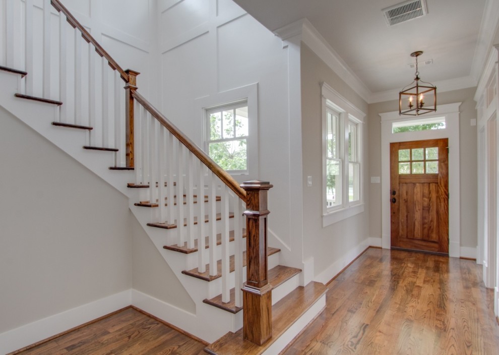 Large classic front door in Houston with white walls, medium hardwood flooring, a single front door, a brown front door and brown floors.