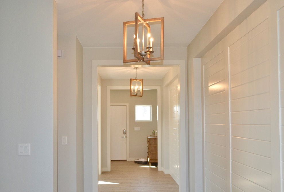 Inspiration for a medium sized beach style hallway in Other with white walls, light hardwood flooring, a single front door, a white front door and beige floors.