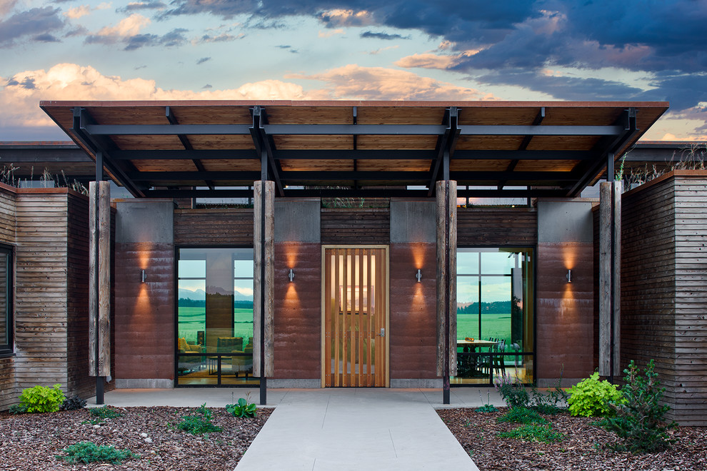 This is an example of a contemporary front door in Other with a medium wood front door and a pivot front door.