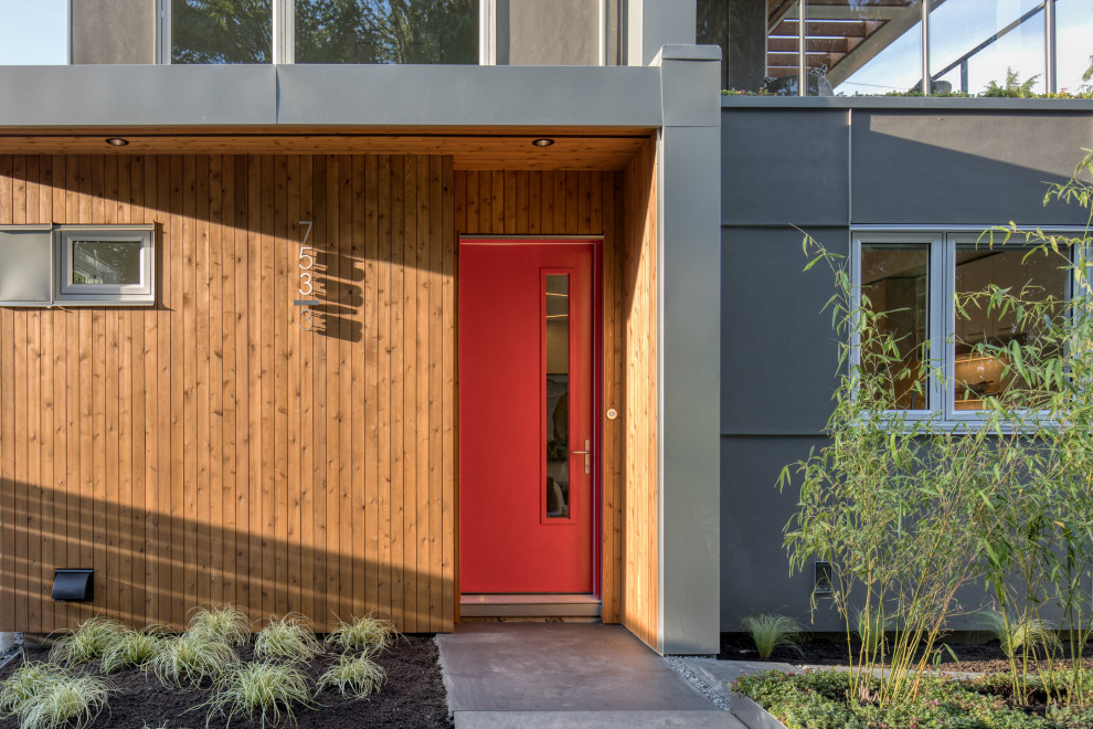 Esempio di una porta d'ingresso minimalista di medie dimensioni con una porta singola e una porta rossa
