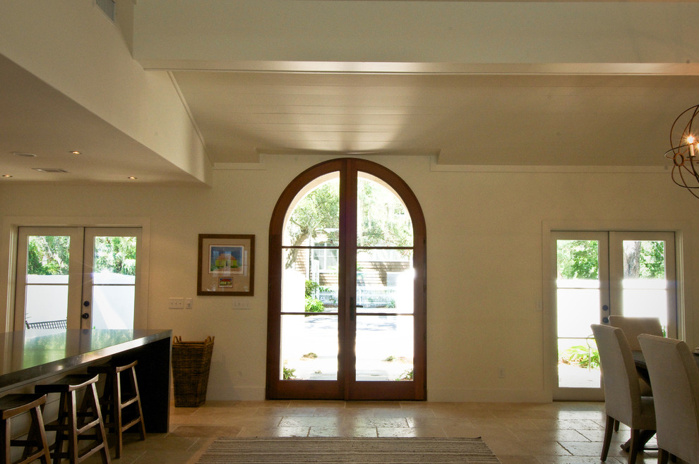 Foto di una porta d'ingresso classica di medie dimensioni con pareti bianche, pavimento in travertino, una porta a due ante e una porta in legno bruno