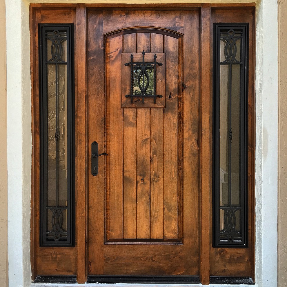 Mid-sized mountain style entryway photo in Miami with beige walls and a dark wood front door