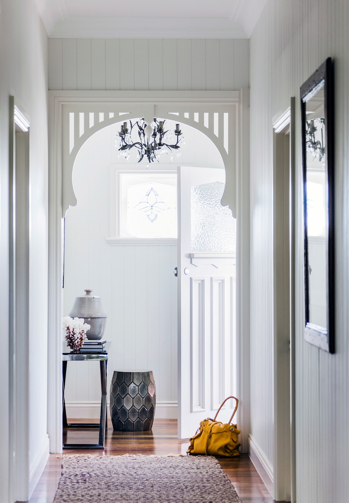 Example of a beach style dark wood floor entryway design in Melbourne with gray walls