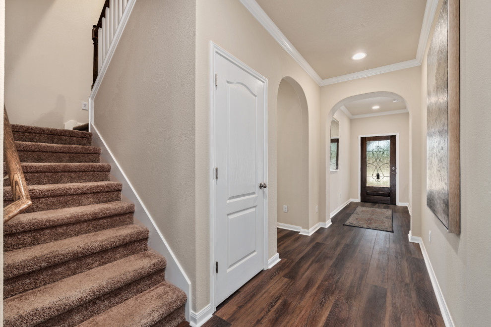 Inspiration for a large craftsman entryway remodel in Austin with beige walls and a dark wood front door