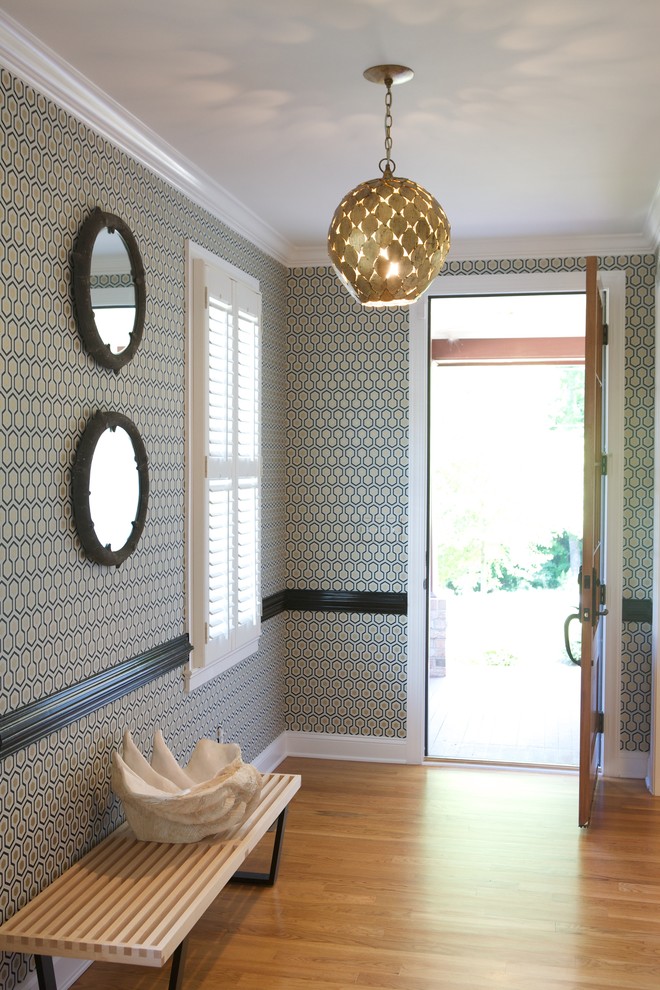 Entryway - contemporary medium tone wood floor entryway idea in Raleigh with multicolored walls