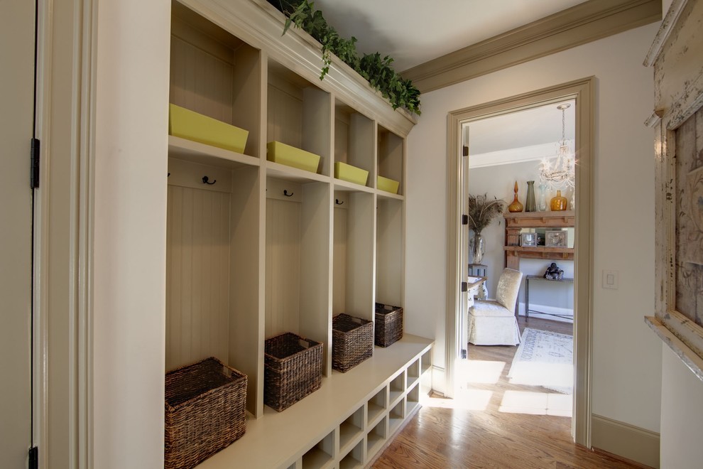 Elegant mudroom photo in Charlotte with beige walls