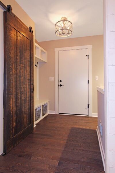 Entryway - eclectic medium tone wood floor entryway idea in Grand Rapids with a white front door