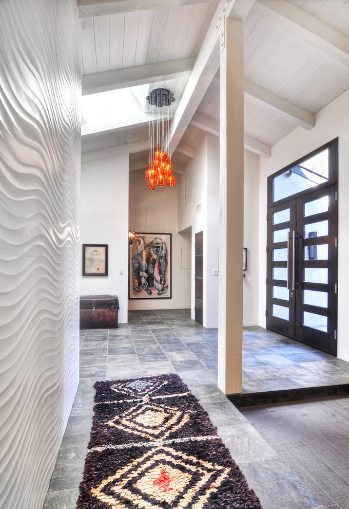 Photo of a large midcentury foyer in Orange County with white walls, slate flooring, a double front door and a dark wood front door.