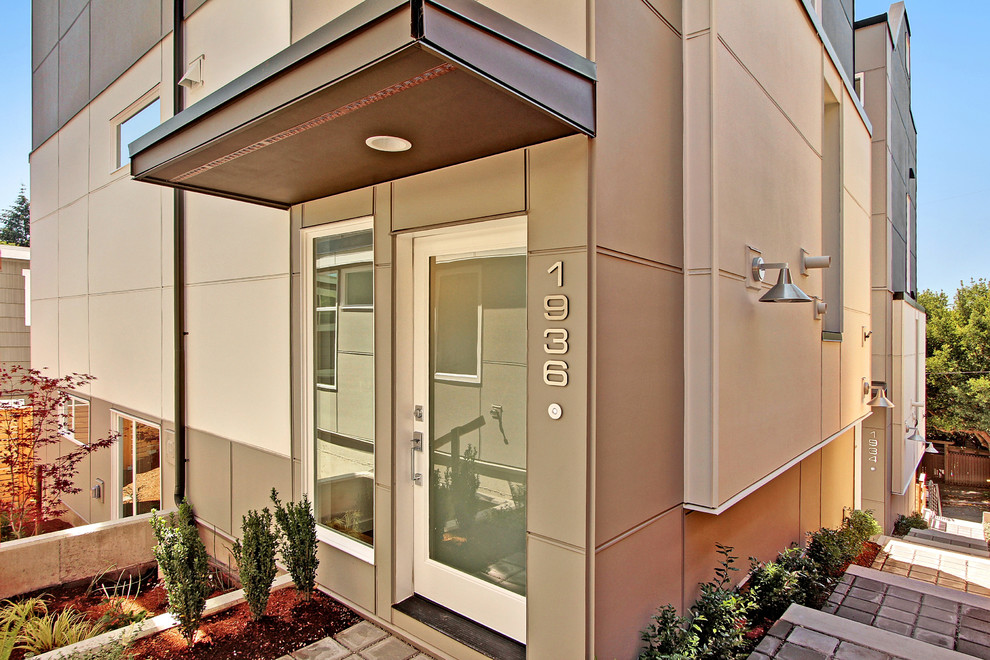 Photo of a medium sized contemporary entrance in Seattle with a single front door and a glass front door.