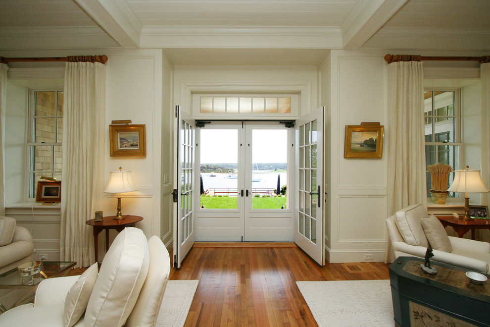 Double front door - large coastal light wood floor double front door idea in Boston with white walls and a white front door