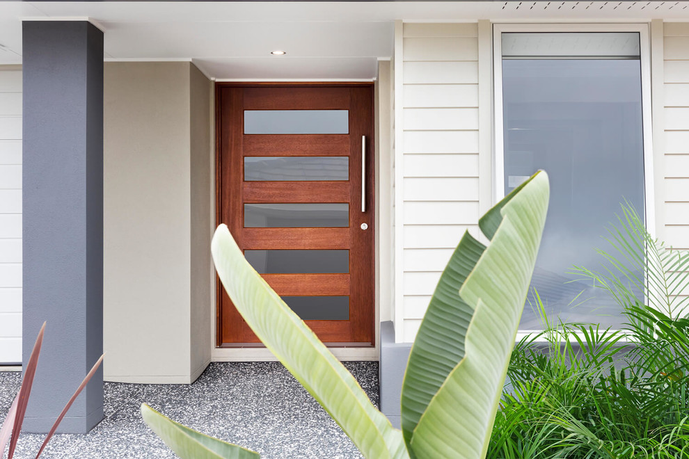 Photo of a modern front door in Gold Coast - Tweed with a single front door and a dark wood front door.