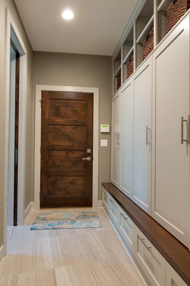Photo of a small contemporary front door in Minneapolis with ceramic flooring, a single front door, a dark wood front door and grey walls.
