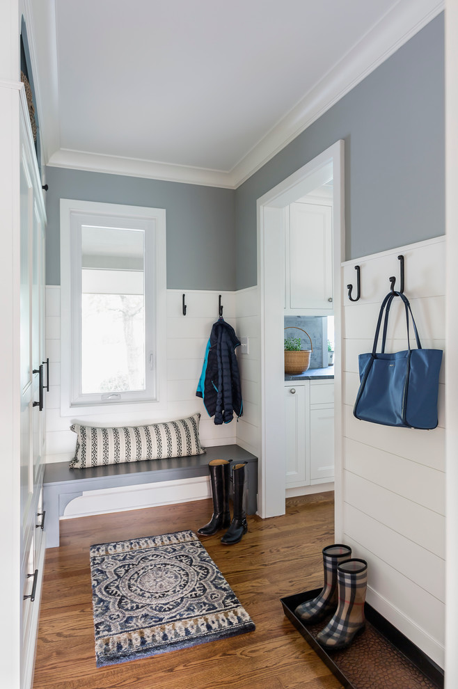 Idee per un piccolo ingresso con anticamera chic con pareti blu, parquet scuro, una porta singola e una porta bianca