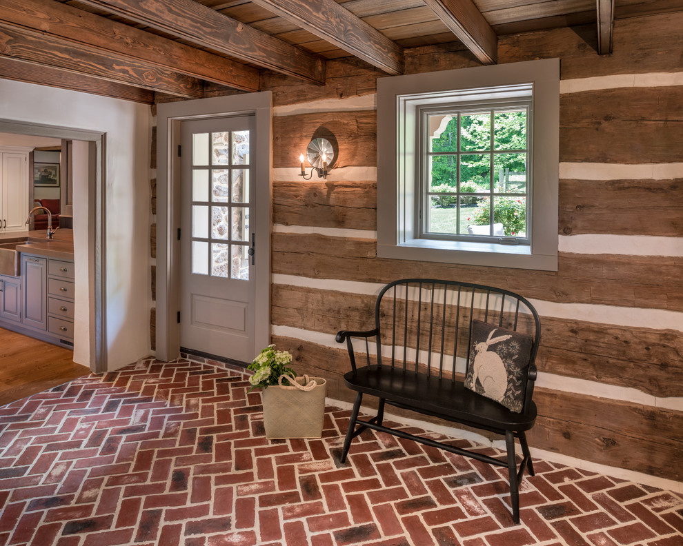 Mid-sized farmhouse brick floor and red floor entryway photo in Philadelphia with white walls and a gray front door