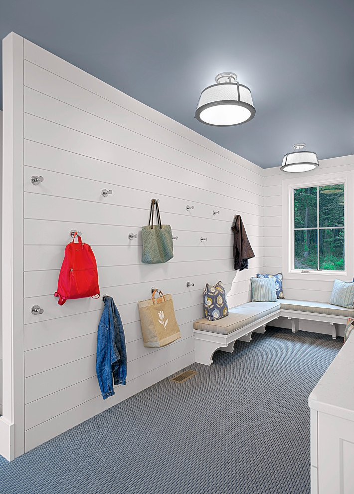 Inspiration for a large timeless carpeted, blue floor and shiplap wall mudroom remodel in Grand Rapids with white walls