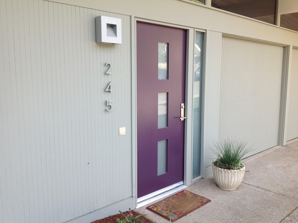 Aménagement d'une porte d'entrée rétro avec sol en béton ciré et une porte simple.