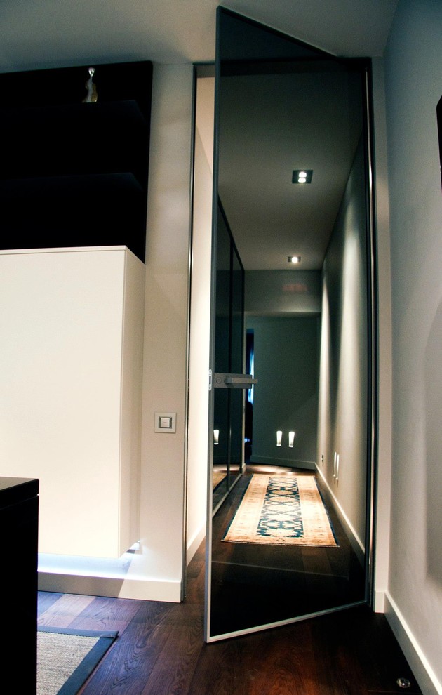 Large minimalist dark wood floor entryway photo in San Francisco with white walls