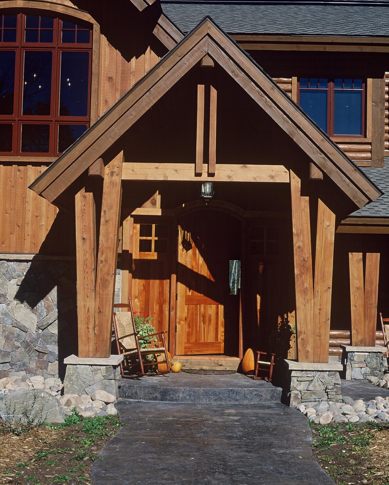 This is an example of a large rustic front door in Denver with a single front door and a light wood front door.